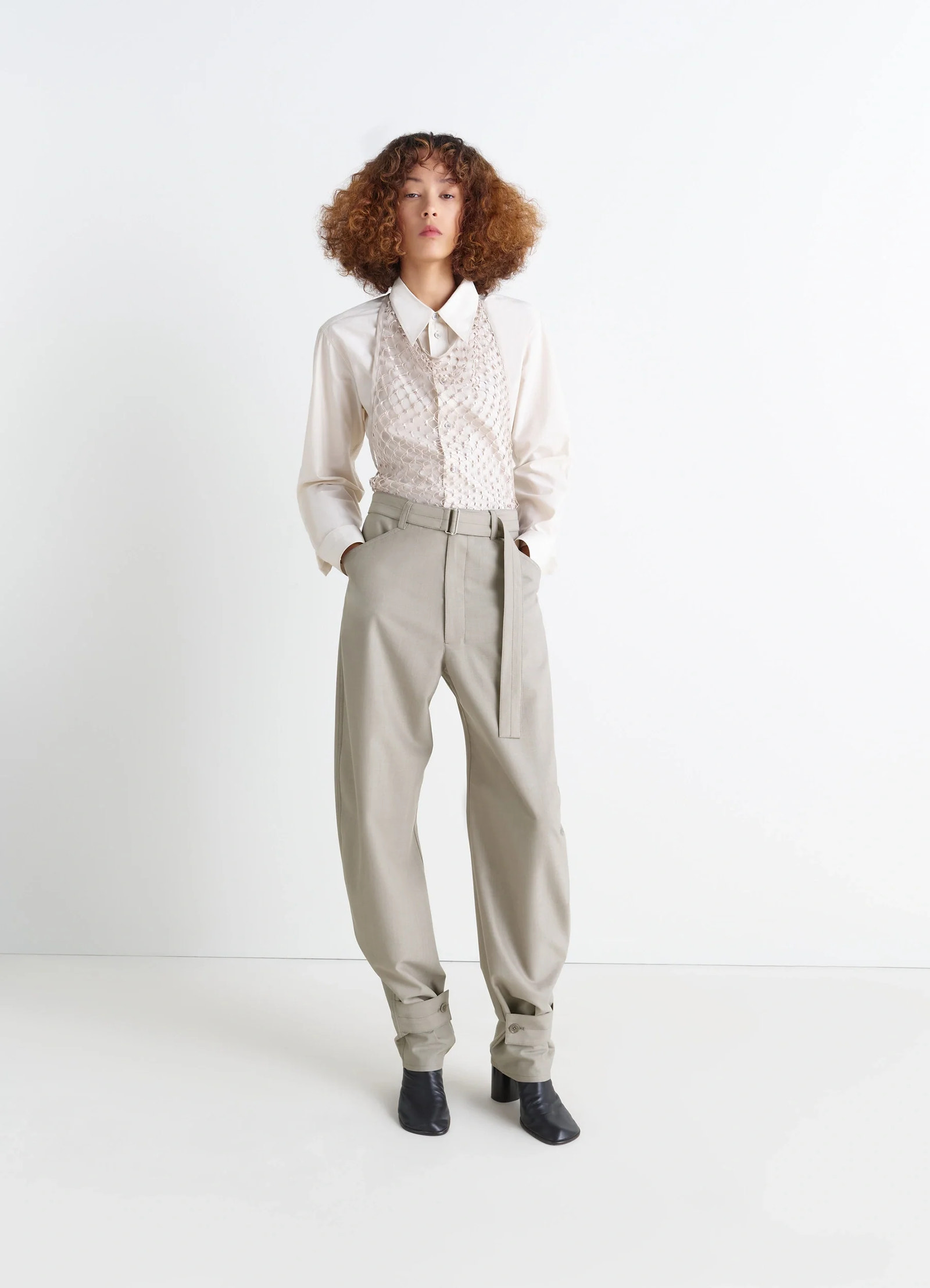Lemaire fishnet halter top in cream fishnet, model shot, full body shot over loose trousers