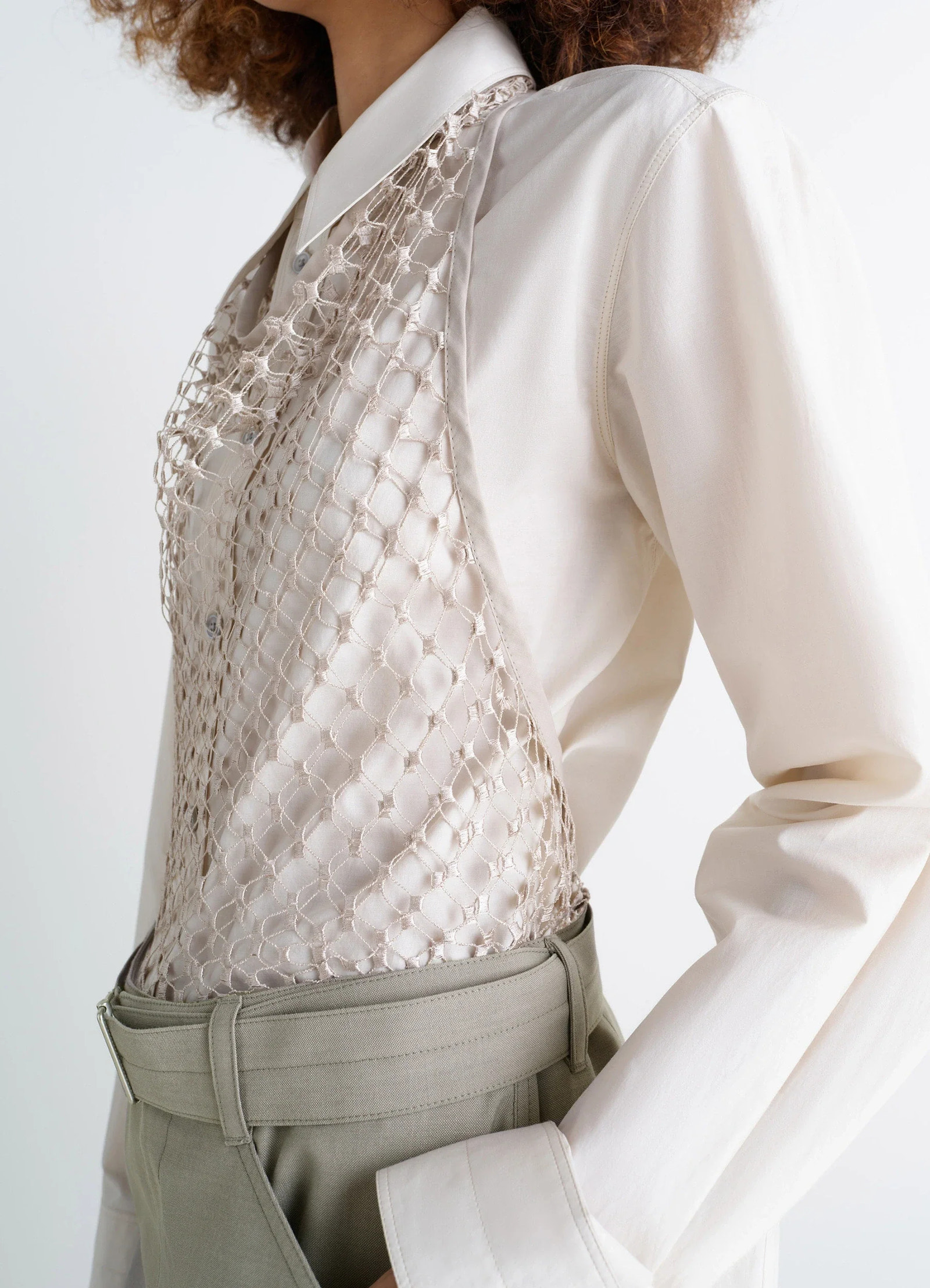 Lemaire fishnet halter top in cream fishnet, model shot, side view worn over long-sleeve shirt