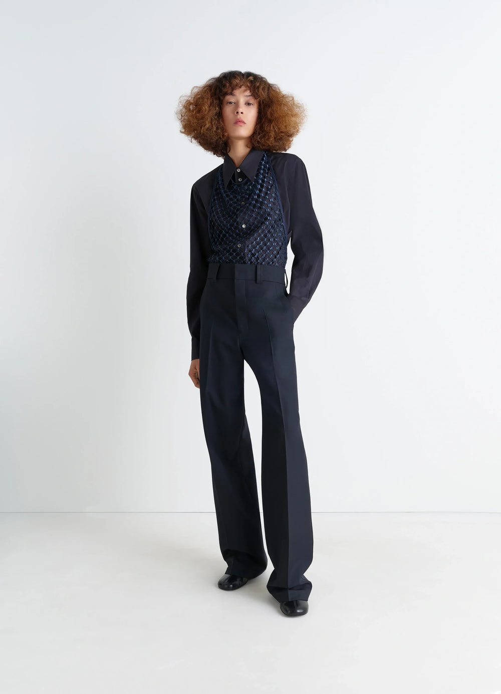 Fishnet Halter Top in Dark Blue Fishnet, model shot, three-quarter view paired with trousers