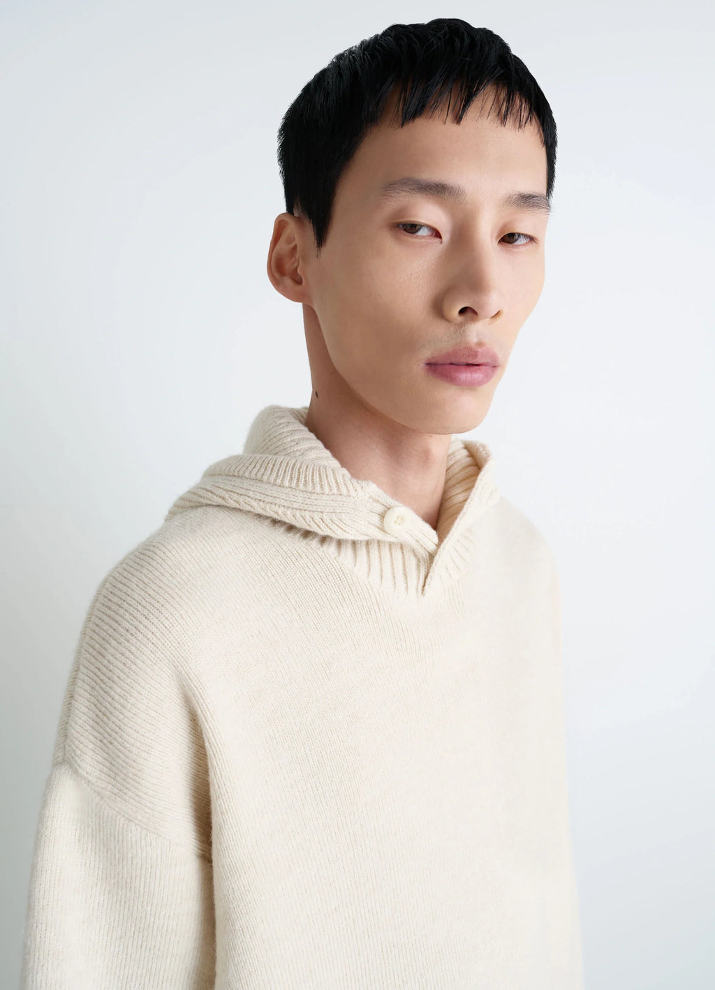 Lemaire Hooded Sweater in Cream Wool Alpaca, model shot, close-up portrait view ribbed neckline detail