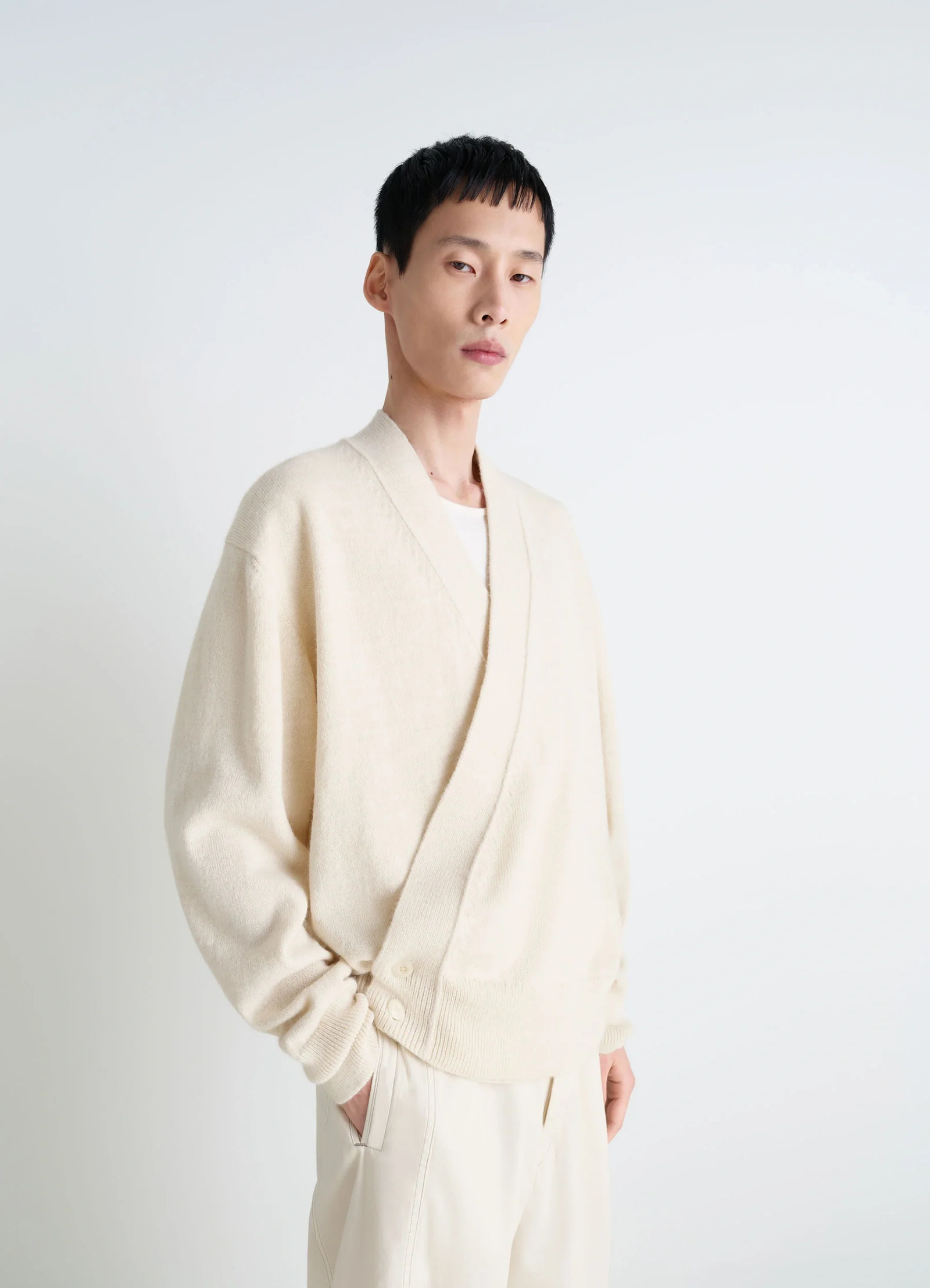 Lemaire wrap cardigan in ivory wool alpaca, model shot, side front view double-breasted relaxed fit