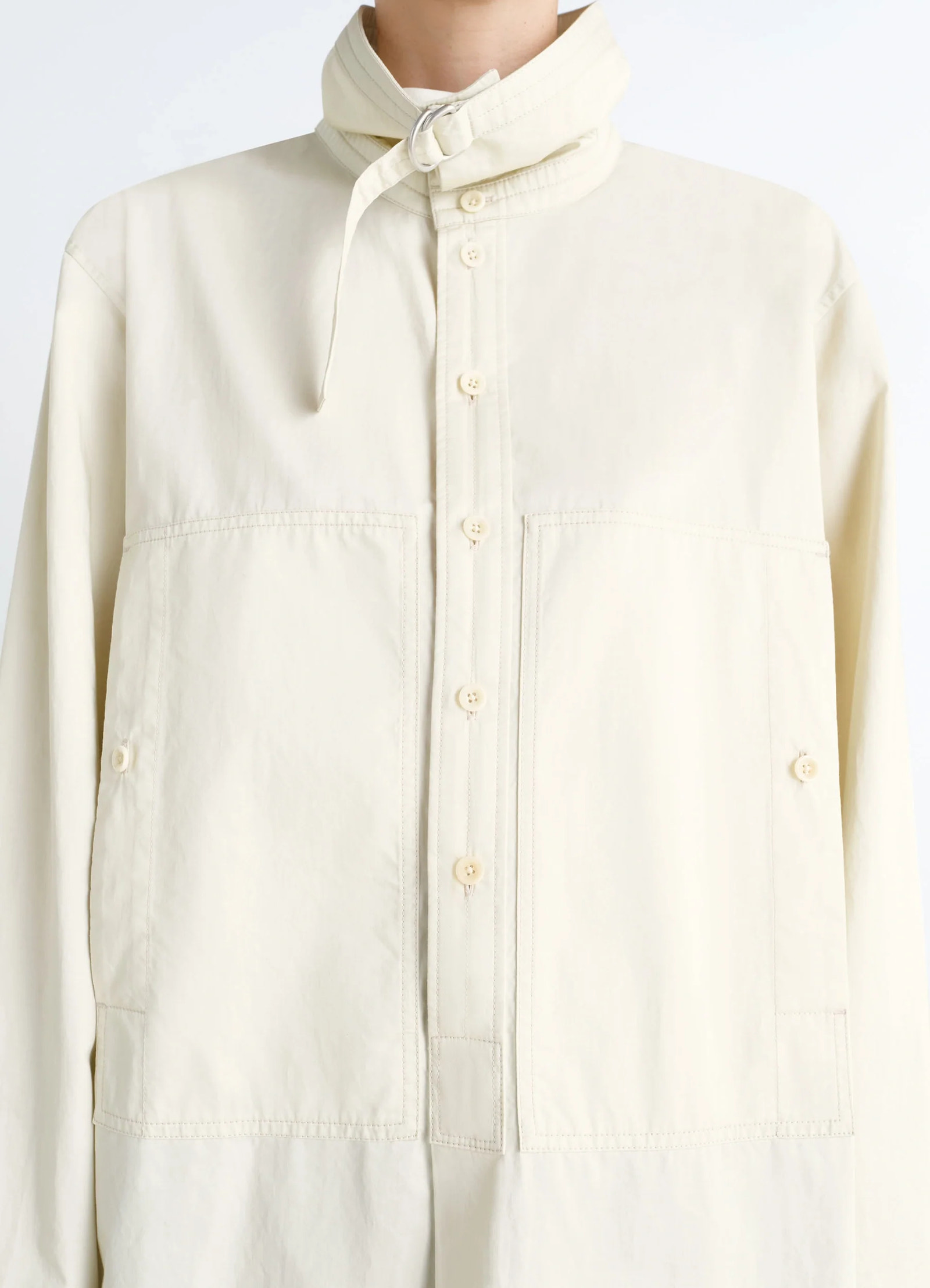 Lemaire chest pocket long liquette in lightweight satin cotton, model shot, button placket close-up adjustable tab collar clo