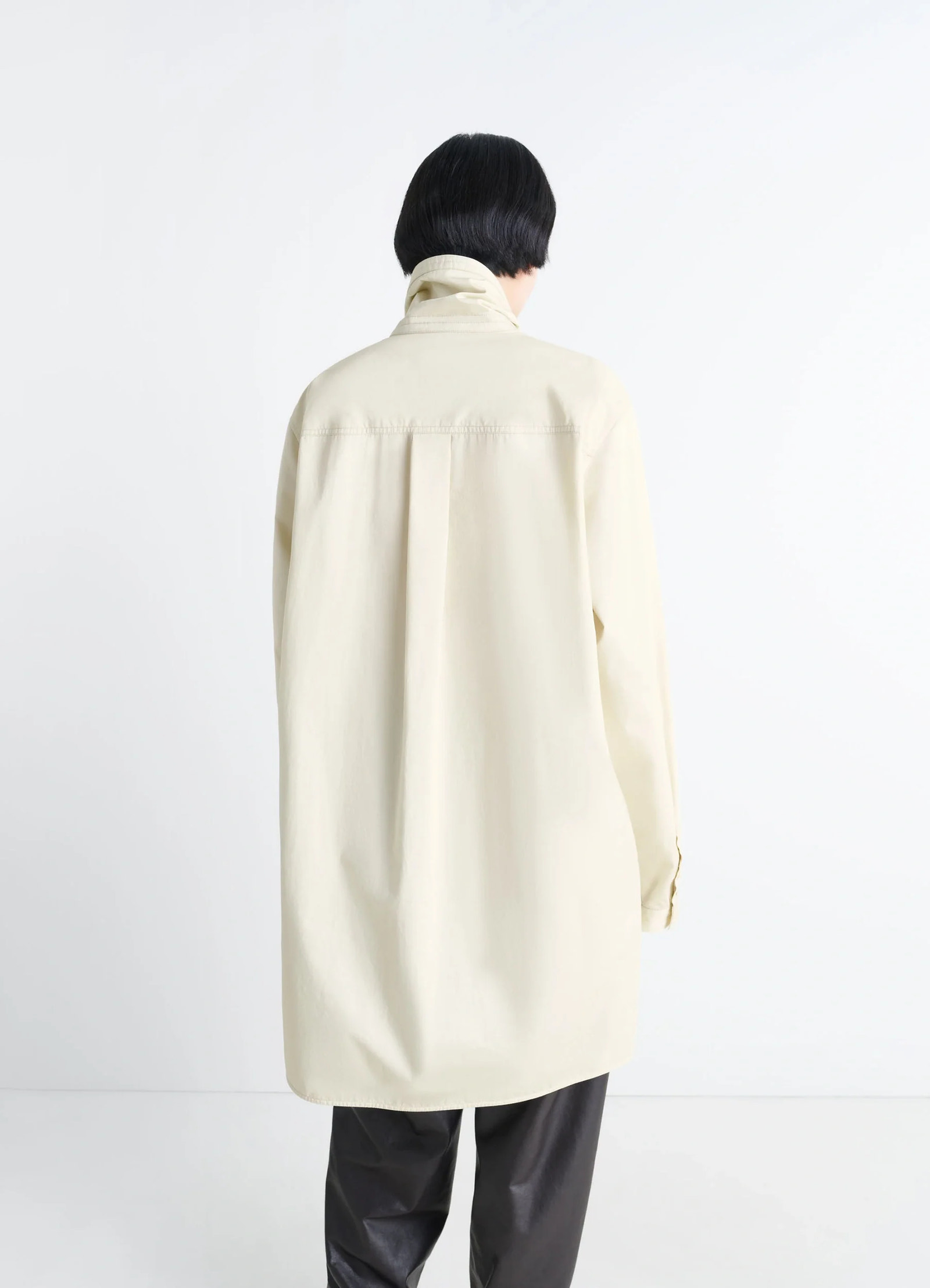 Lemaire chest pocket long liquette in lightweight satin cotton, model shot, back view rear pleat detail visible