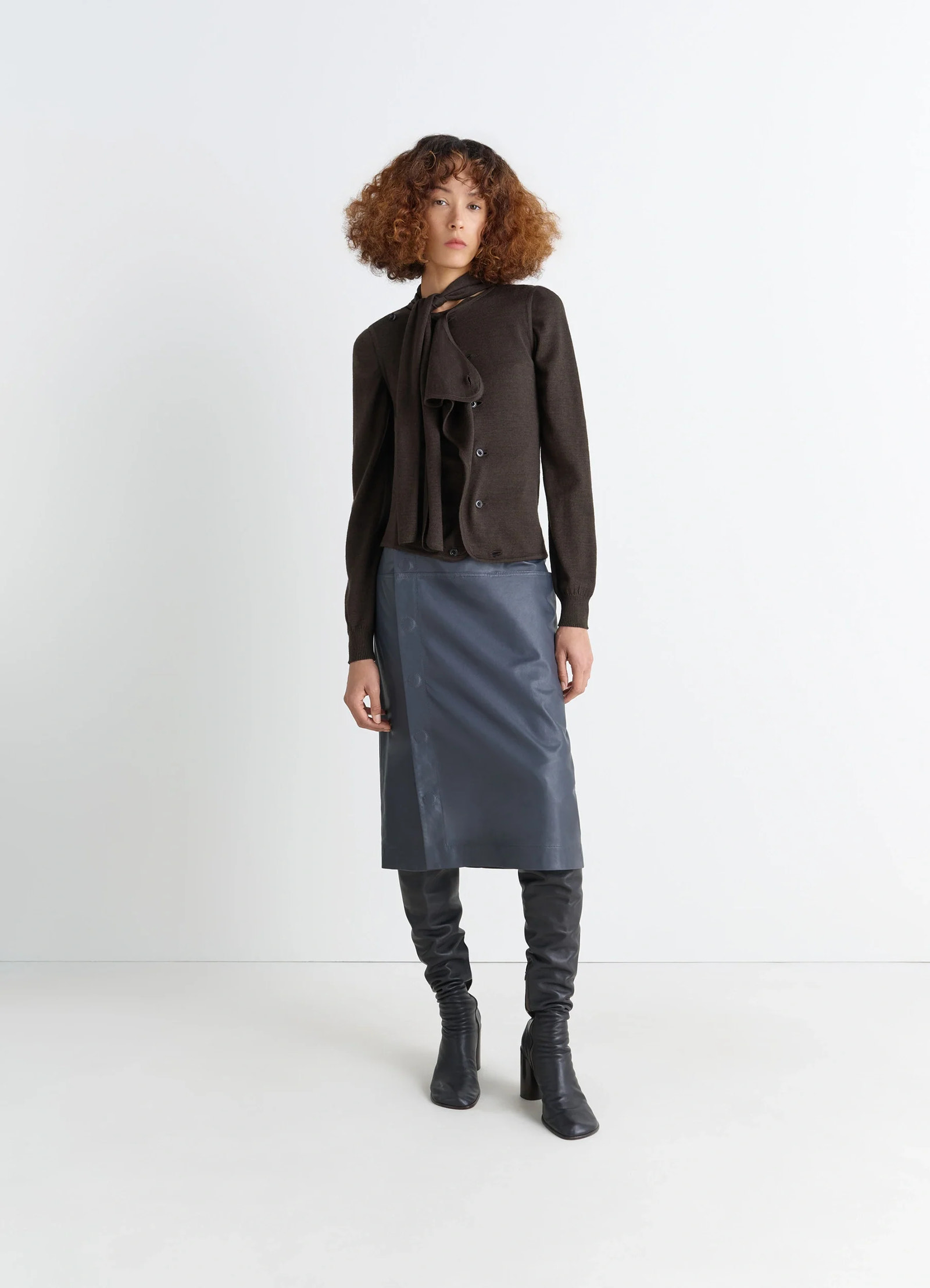 Lemaire asymmetrical sleeveless car in blended merino wool, model shot, side view asymmetrical button closure