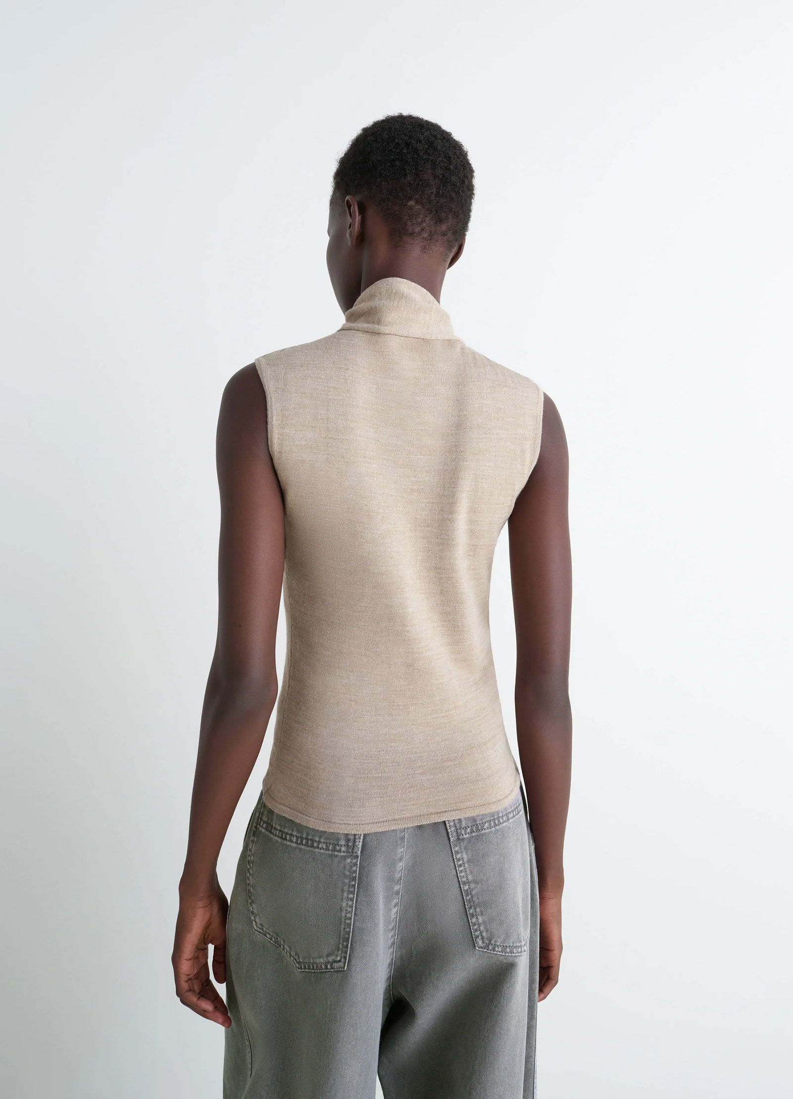 Lemaire asymmetrical sleeveless car in blended merino wool, model shot, back view collar detail, fitted cut