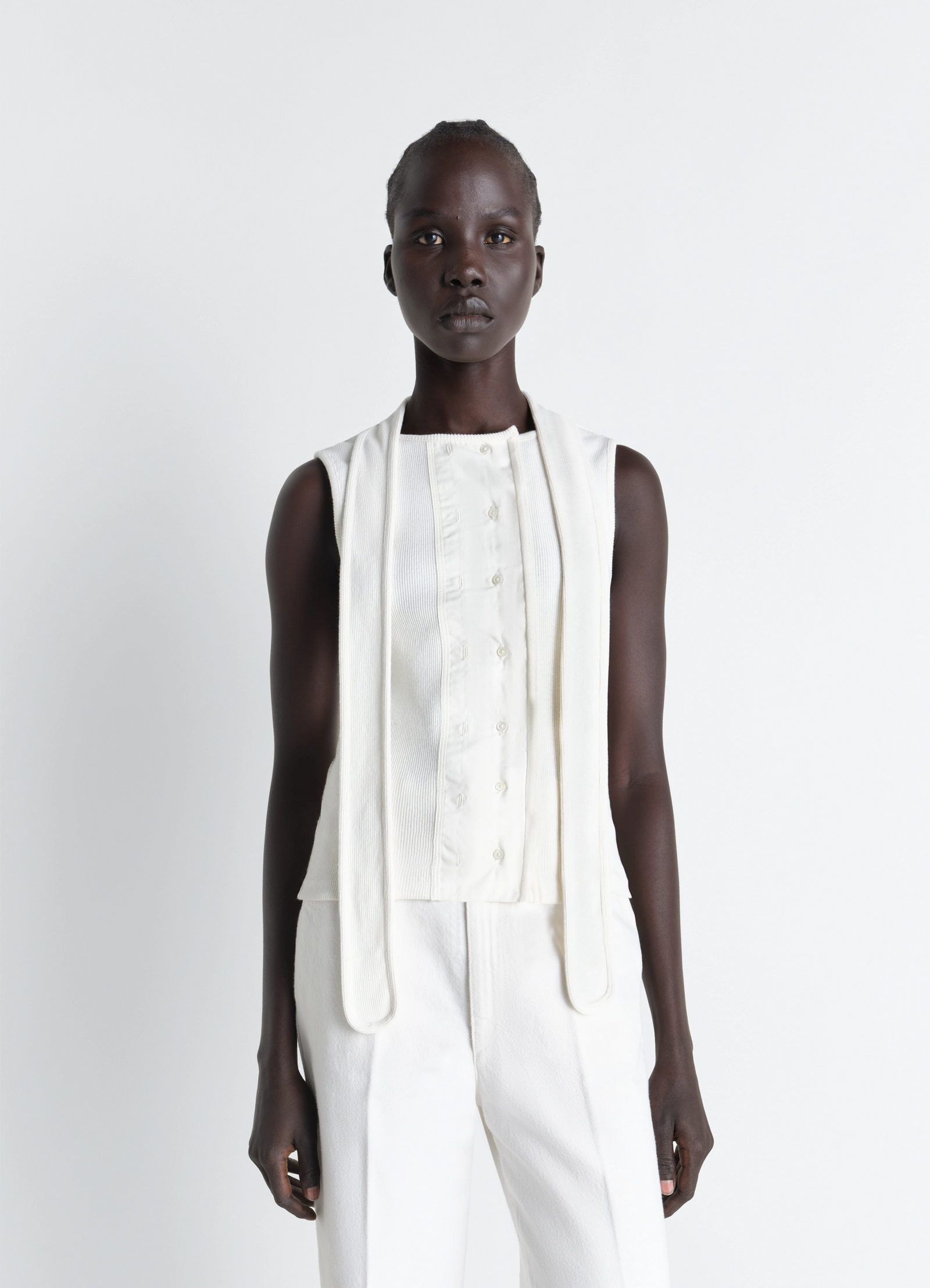 Asymmetrical fitted top in white cotton lined rib jersey, model shot, front view sleeveless with neck scarf