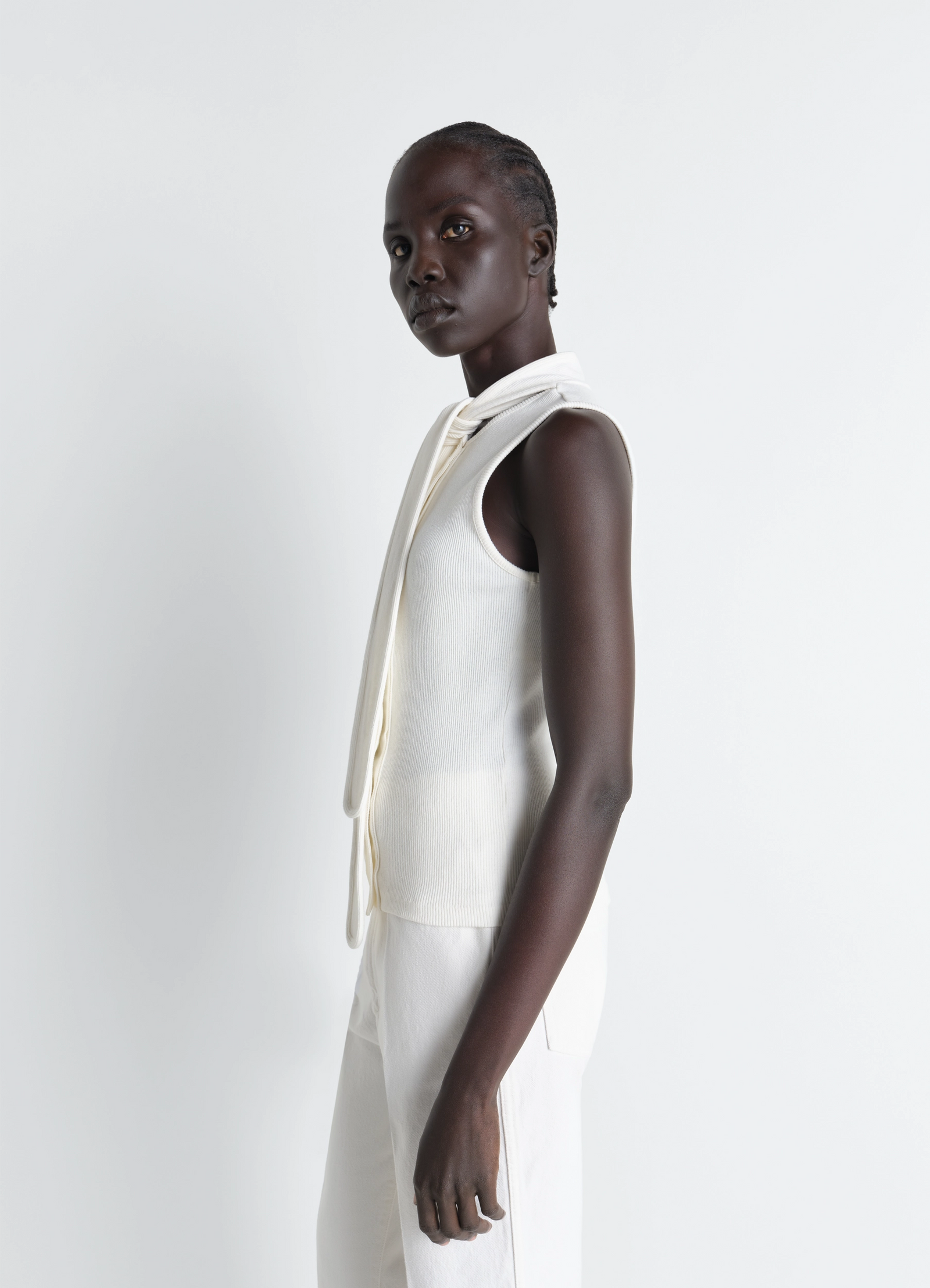 Asymmetrical fitted top in white cotton lined rib jersey, model shot, side view sleeveless with neck scarf view 3