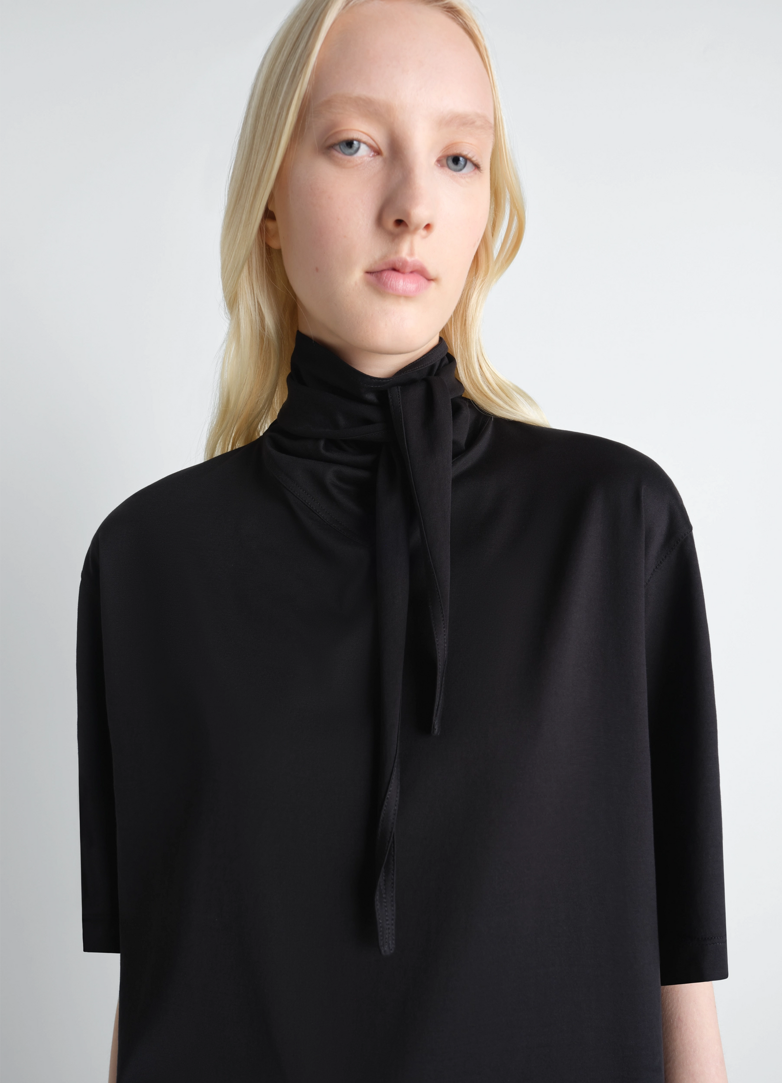 Lemaire t-shirt with foulard in black cotton jersey, model shot, close-up view tie neck detail