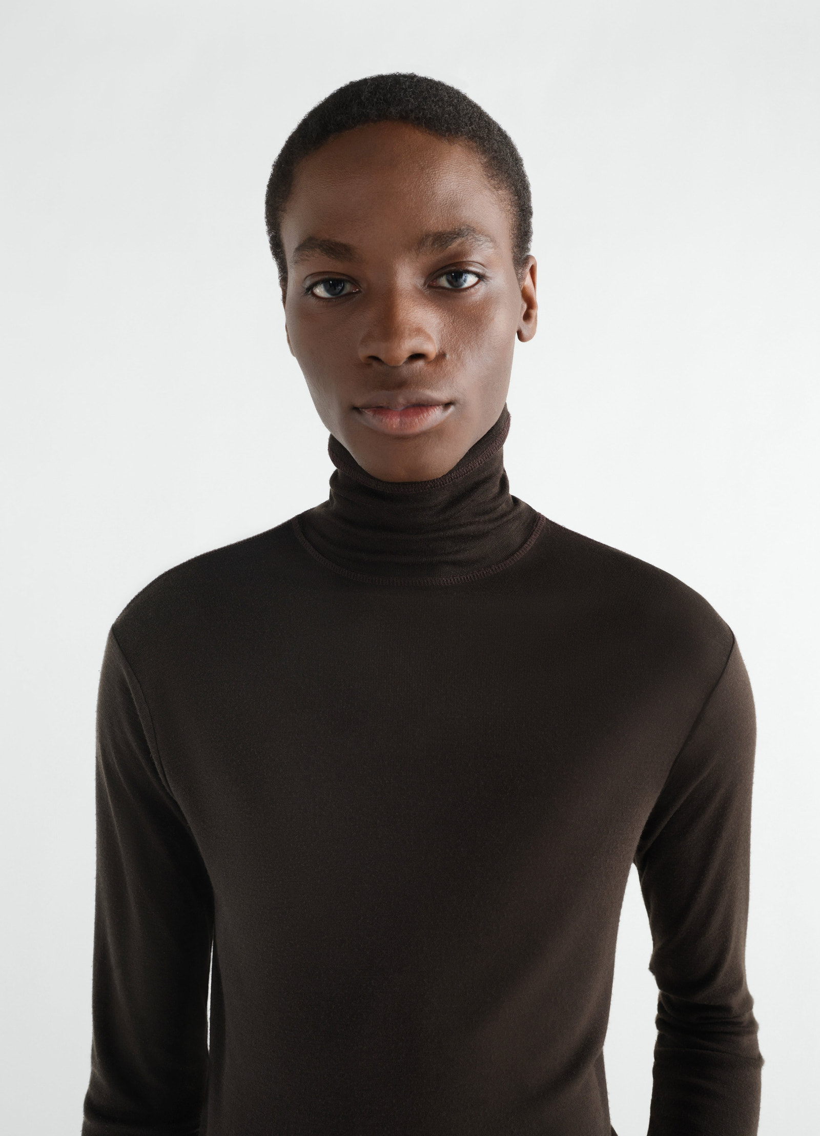 Stand-collar long sleeve top in dark brown wool and silk jersey worn by model front lemaire