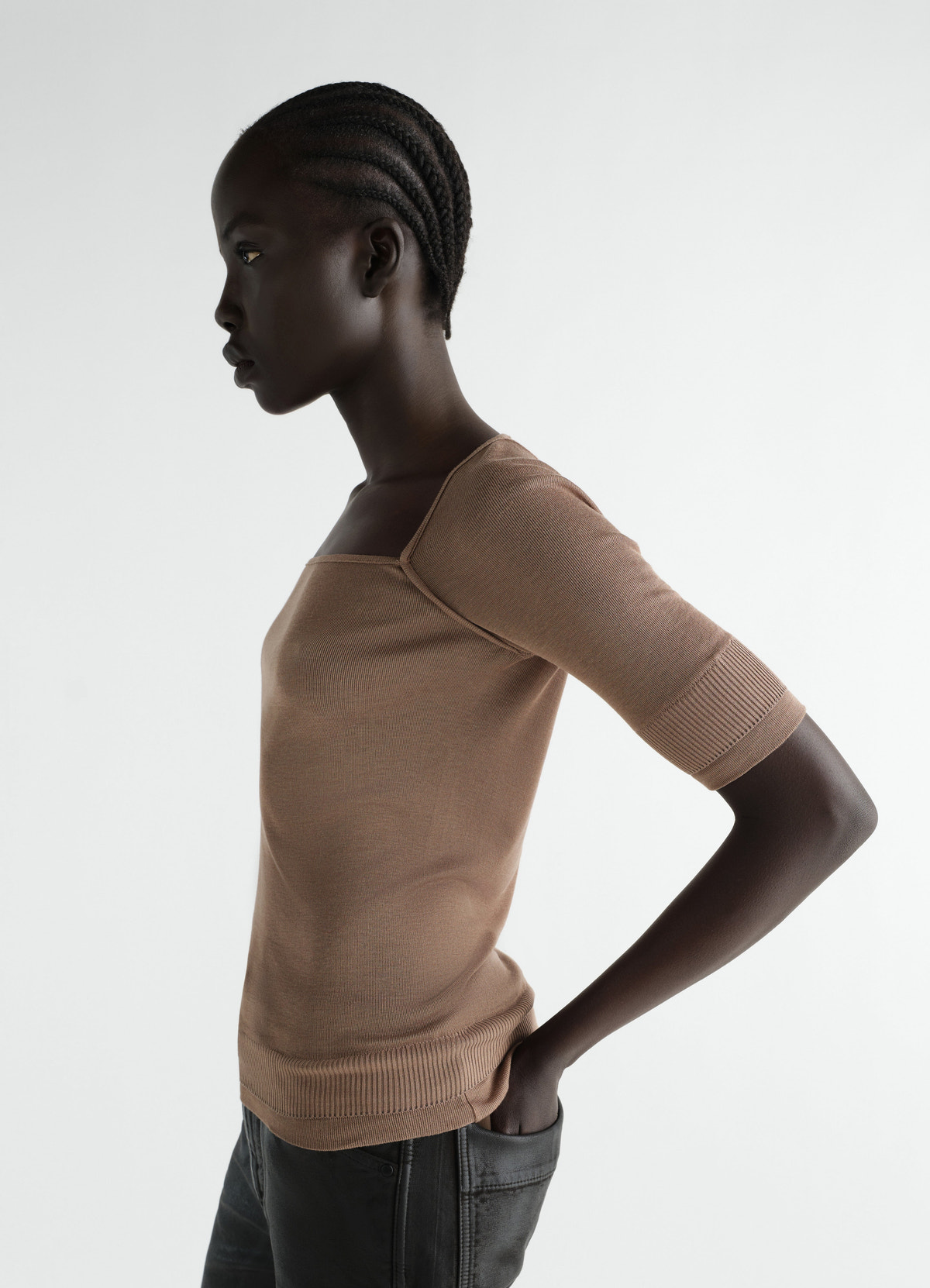 Three-quarter sleeve silk blend top in brown lemaire worn by model side view on white background