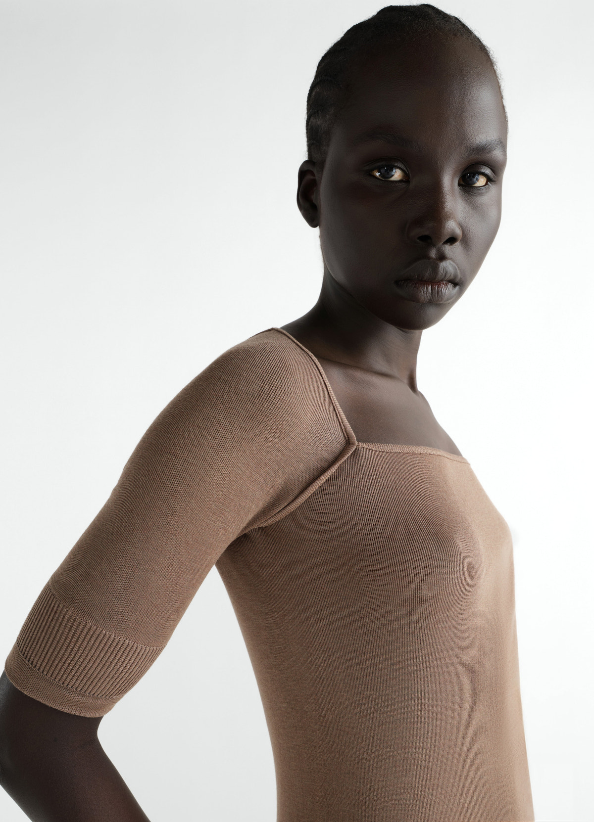 Three-quarter sleeve brown silk blend top by lemaire worn by model front close-up