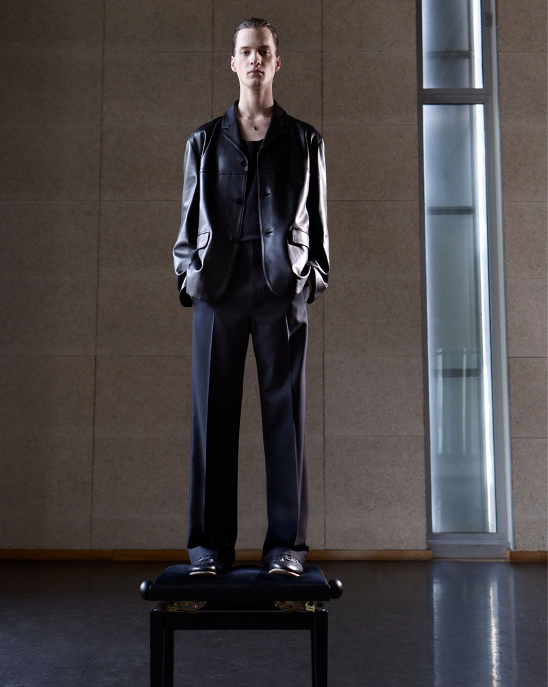 Leather jacket and pants in black leather and fabric, model shot, front view loose fit