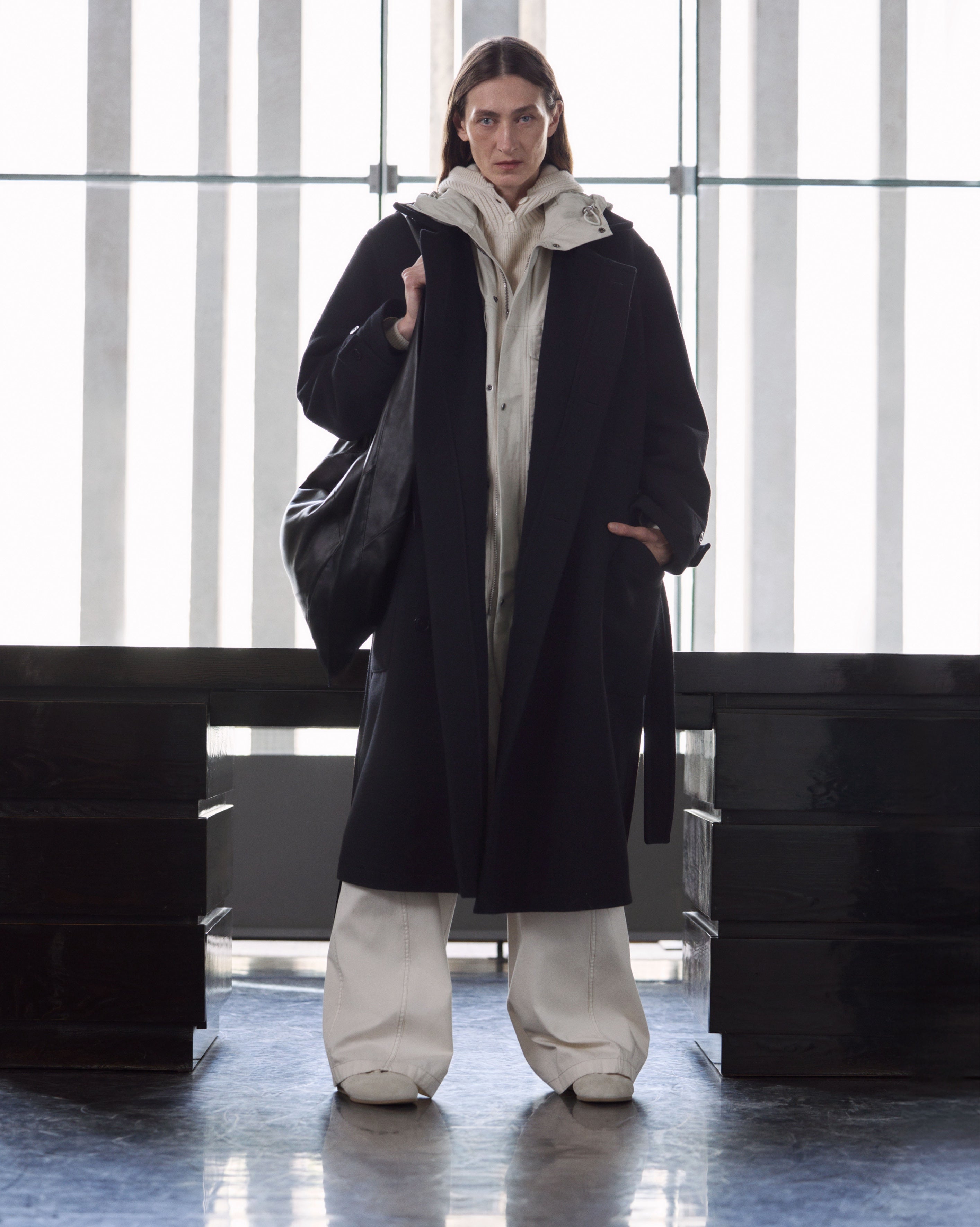 Black coat in Black fabric, beige fabric, model shot, Front view Long, oversized, wide leg