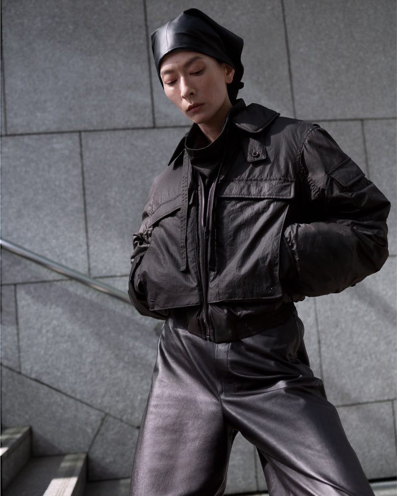Black jacket and pants in Black leather look, model shot, Front angle view Loose fit