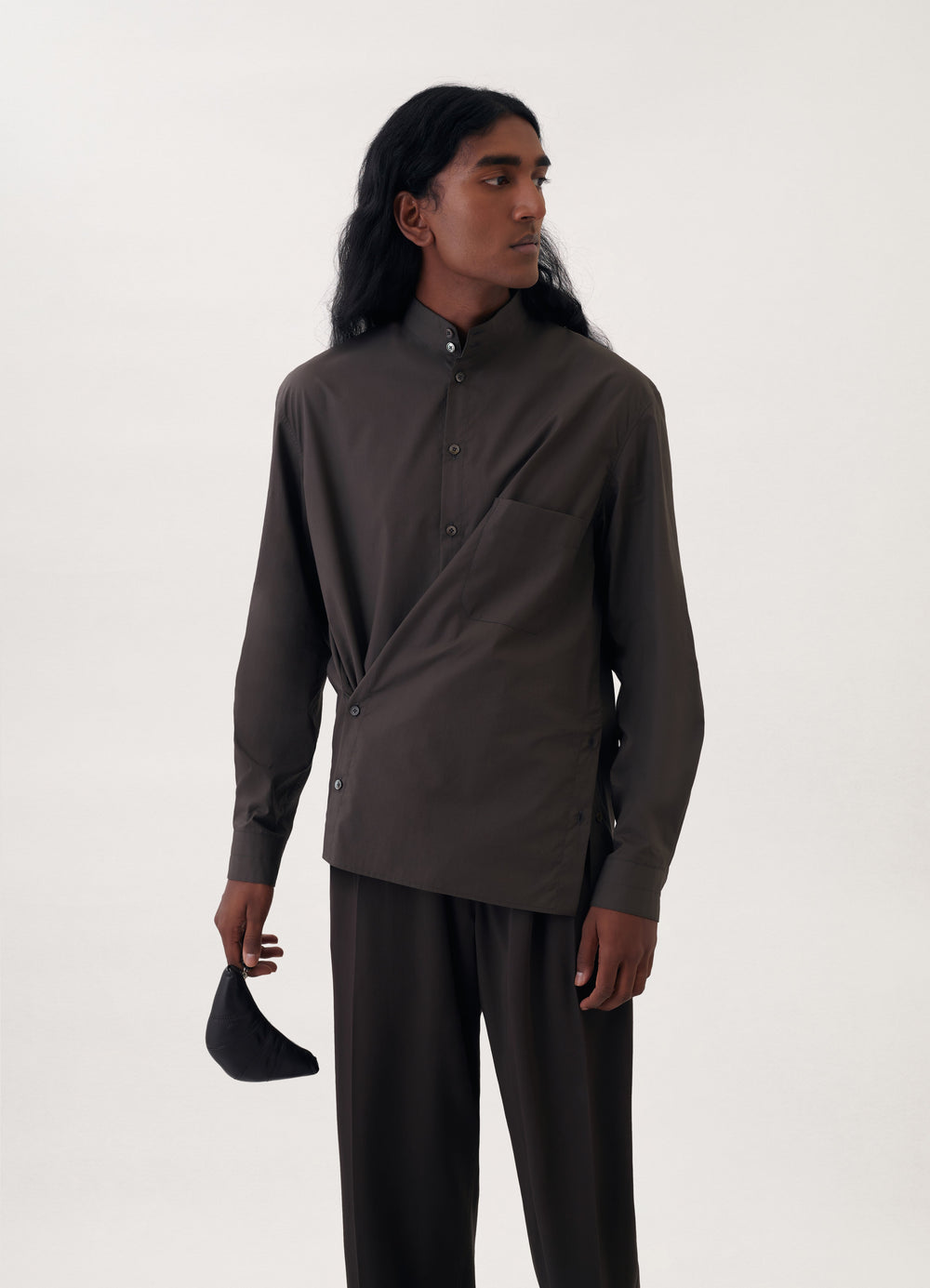 Croissant Coin Purse in Smooth Nappa Leather, model shot, held side angle compact hand-held