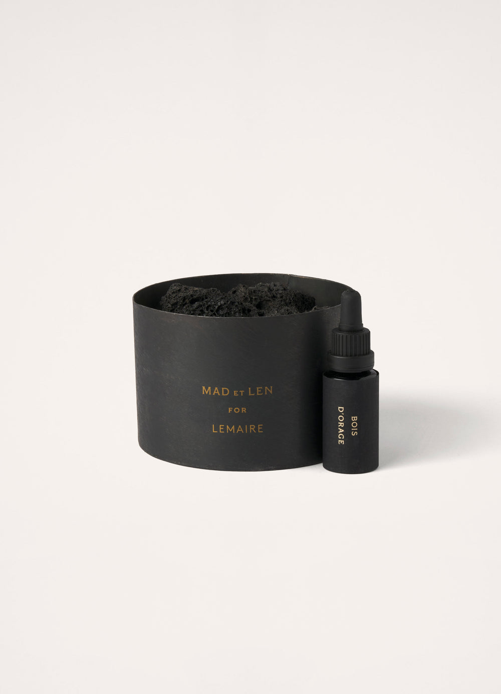 Mad et Len for Lemaire Bois d’Orage in Black Metal and Lava Stone, product shot, Front angled view Round pot with dropper bot