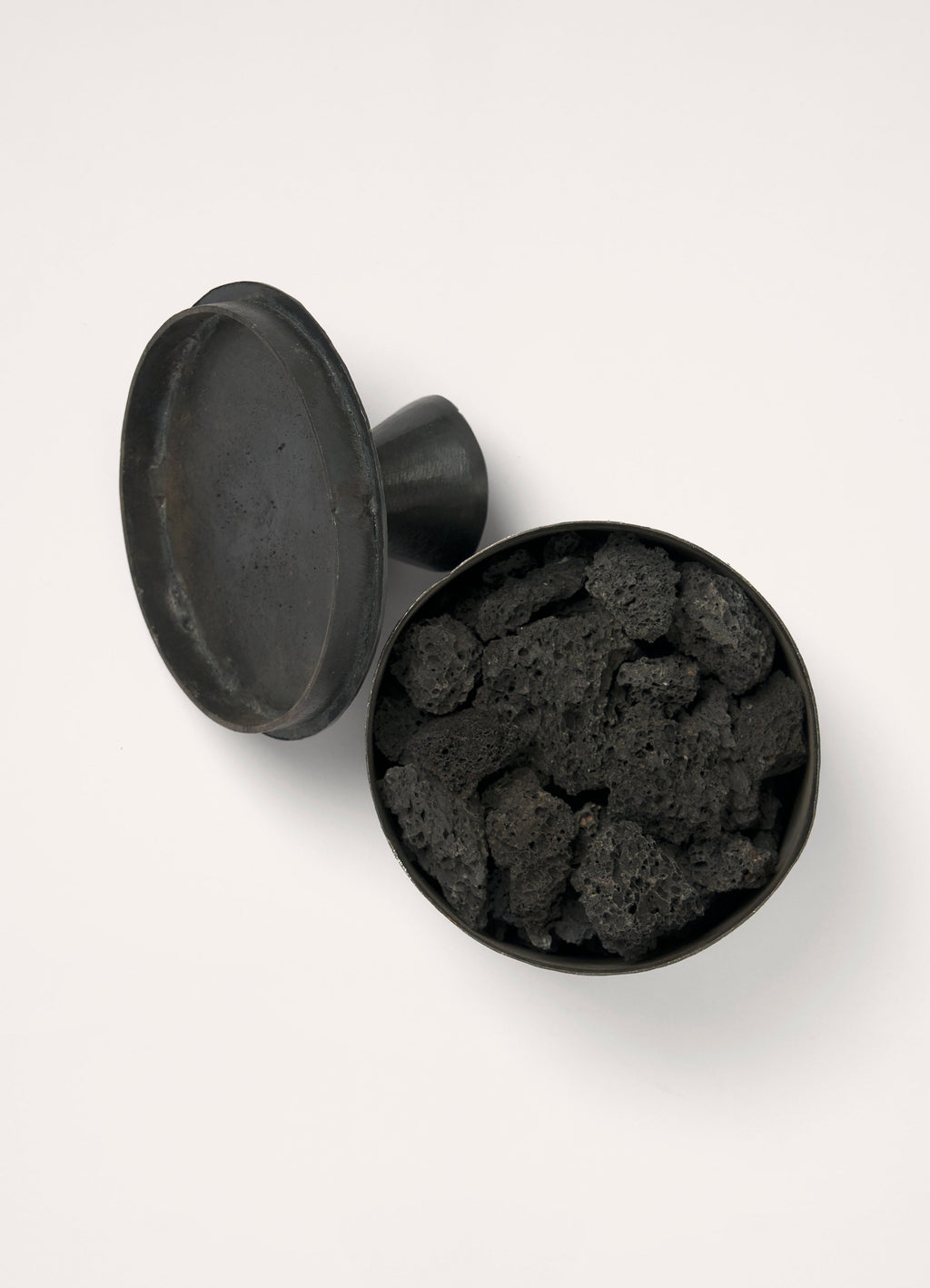 Mad et Len for Lemaire Bois d’Orage in Black Metal and Lava Stone, product shot, top view open lid with lava stones