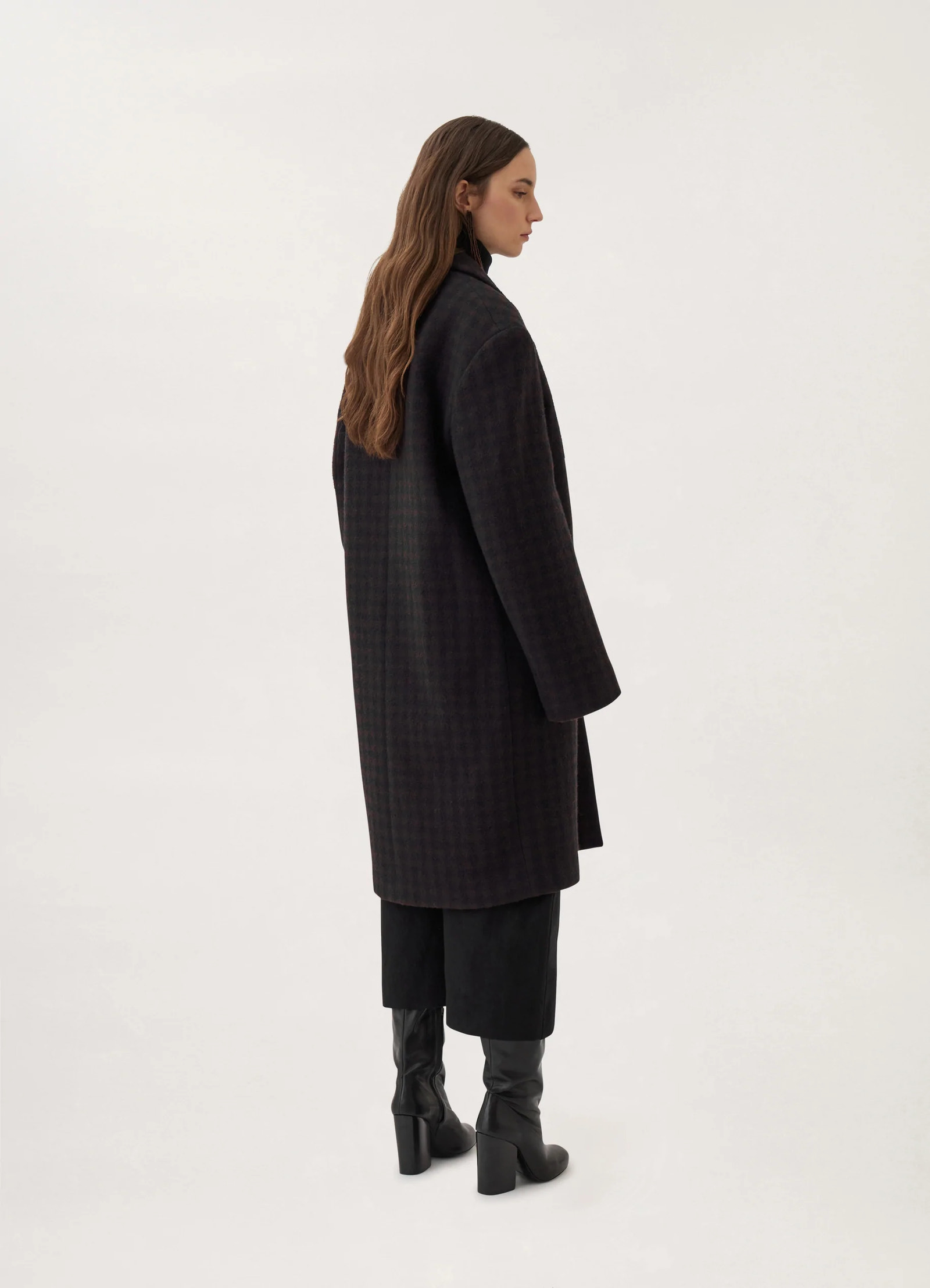 Lemaire chesterfield coat in brown/marine, model shot, back three-quarter view long back slit