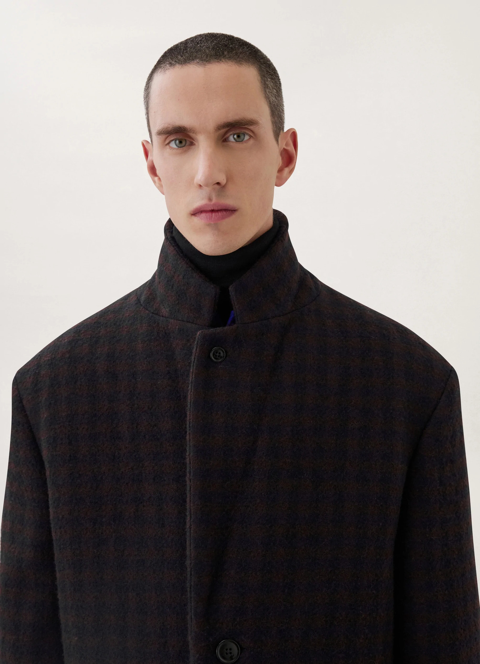 Lemaire chesterfield coat in brown/marine, model shot, close-up collar view high neck button closure