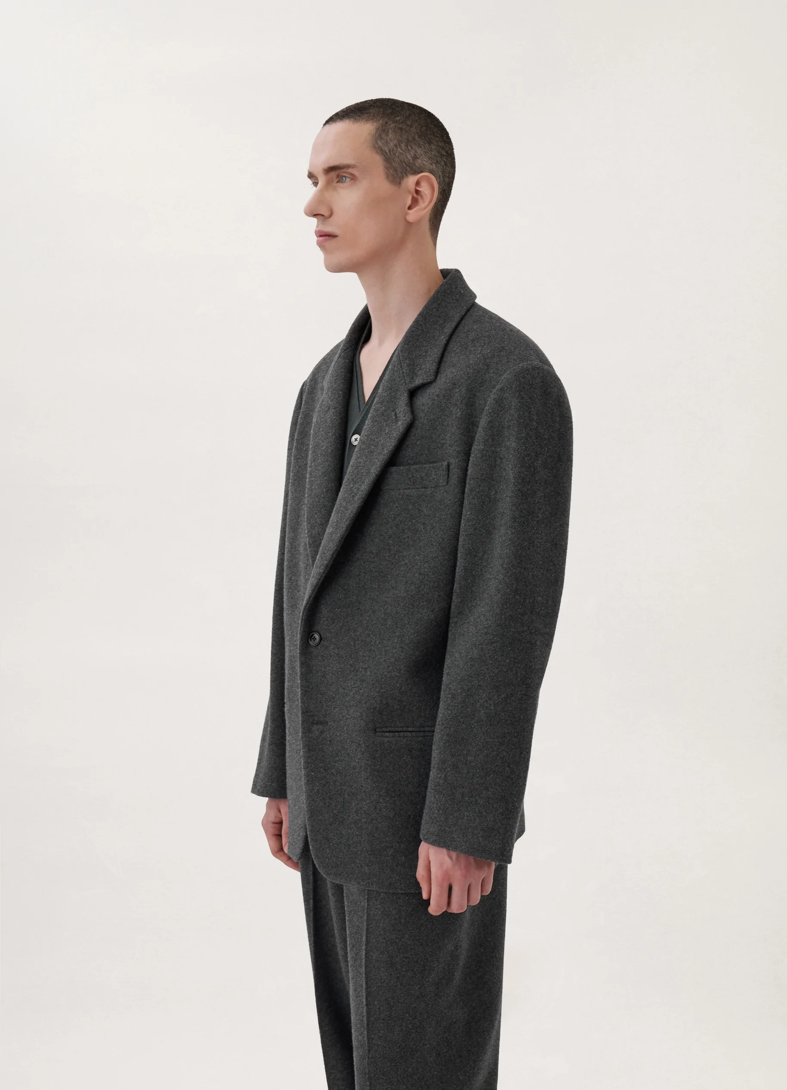 Lemaire boxy single-breasted jacket in felted wool, model shot, three-quarter view minimalist notch lapel