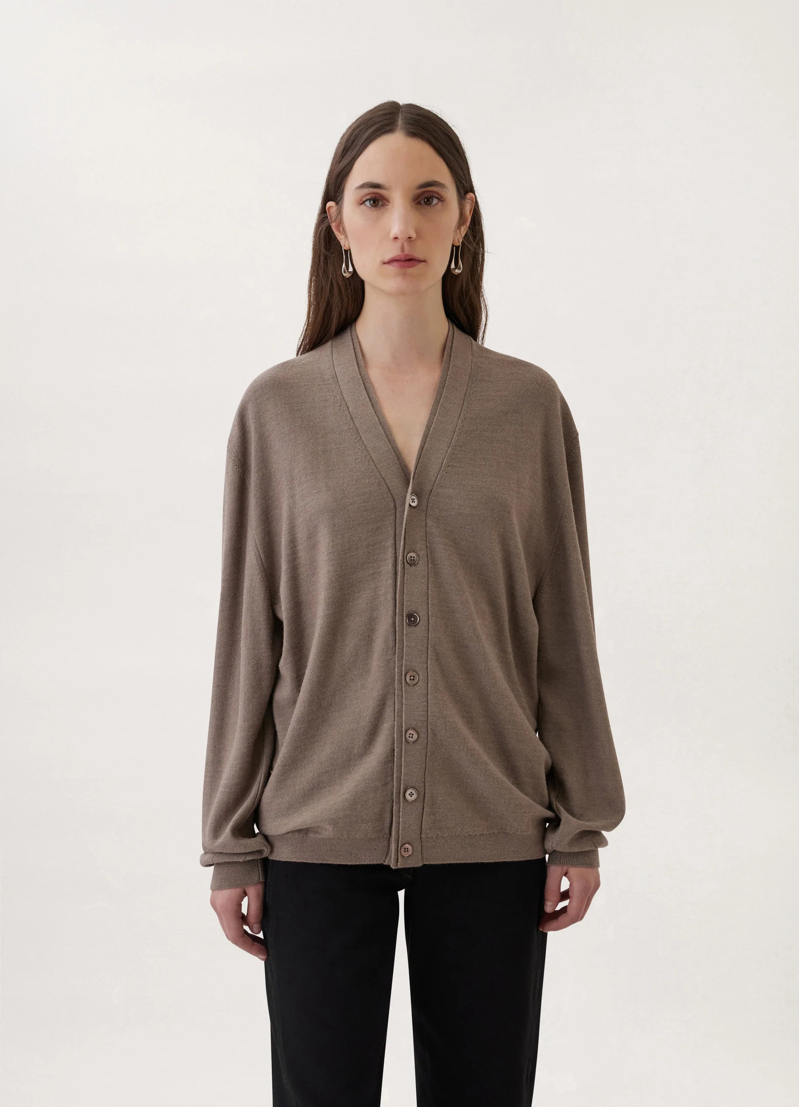 Loosely crafted cardigan in heather taupe knit, model shot, front view loose fit silhouette