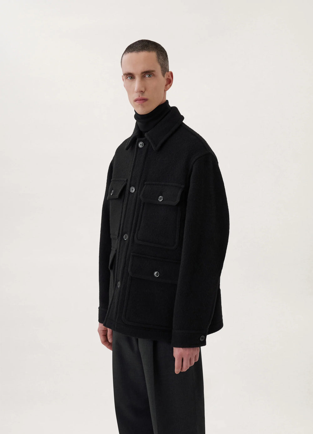 Hunting Jacket in Black Wool, model shot, Three-quarter view Boxy fit, patch pockets