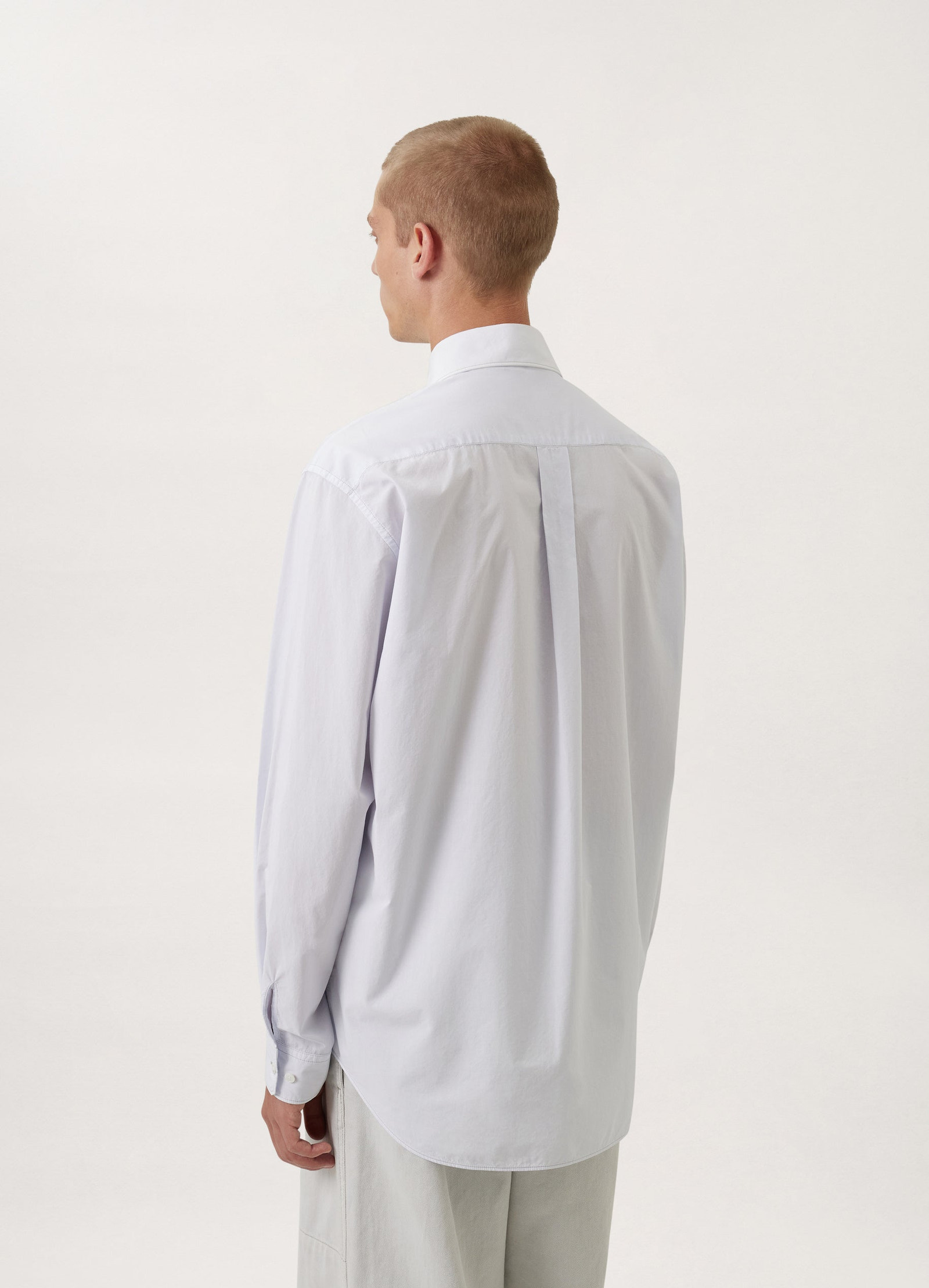 Lemaire regular long sleeve shirt in white compact cotton, model shot, back view back pleat detail