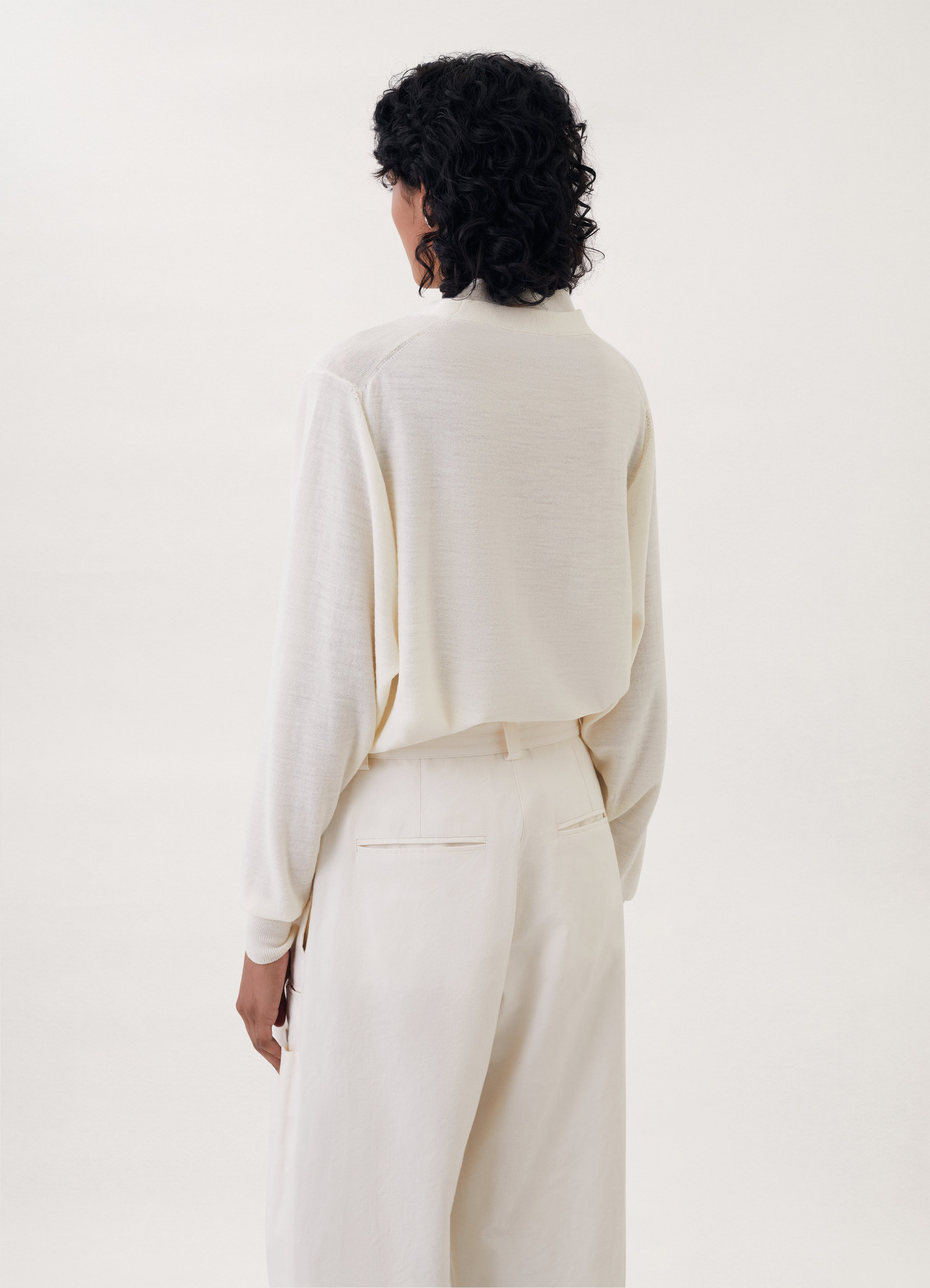Trompe-l’oeil cardigan in cream knit, model shot, back view relaxed fit