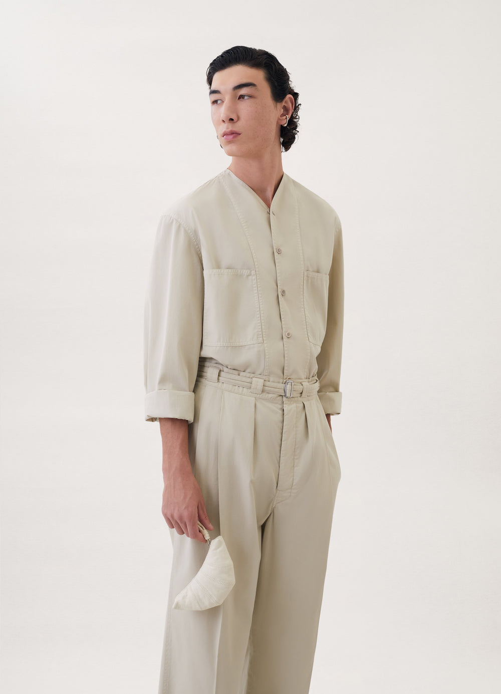 Croissant Coin Purse in Coated Linen Canvas, model shot, side view held rounded shape detail