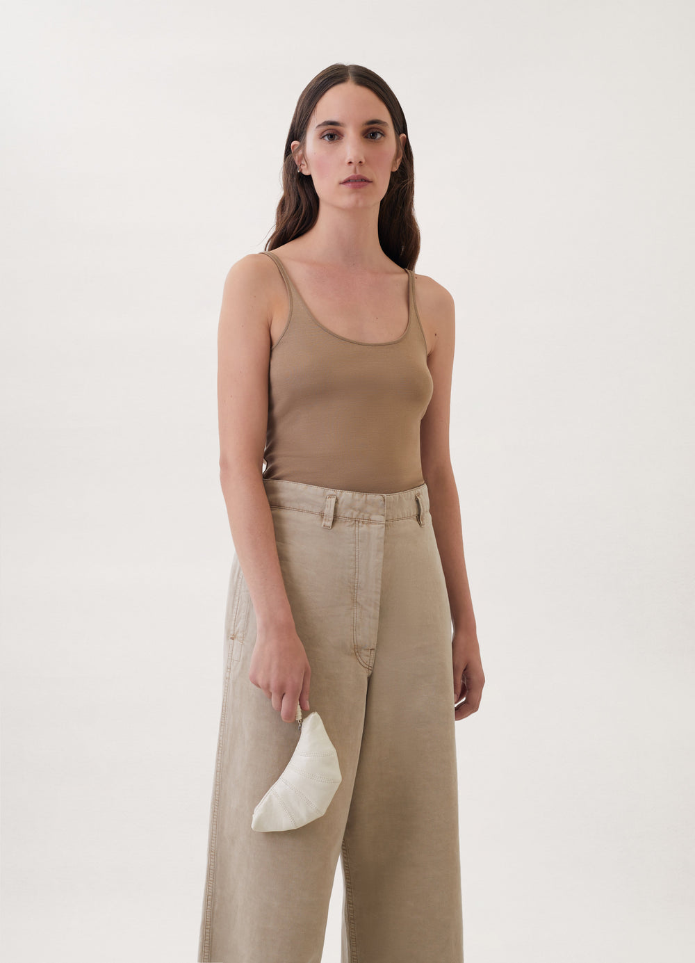 Croissant Coin Purse in Coated Linen Canvas, model shot, three-quarter view held in hand by model