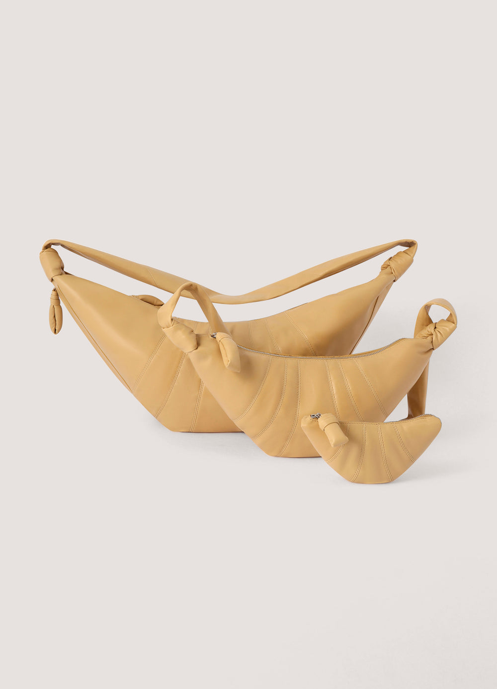 Croissant Coin Purse in Nappa Leather, product shot, group top view knotted handles detail